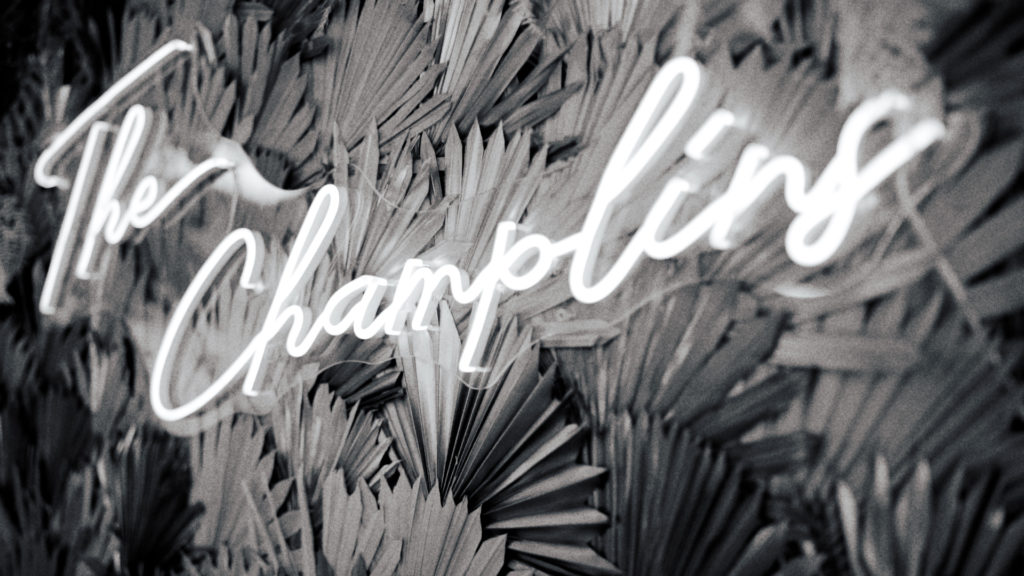 neon sign that read The Champlins