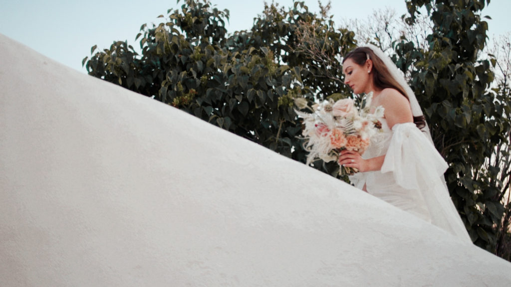 bride walking up white stairs