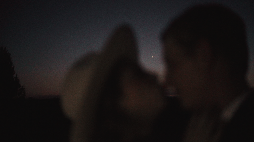 bride and groom kissing under the moon during texas elopement