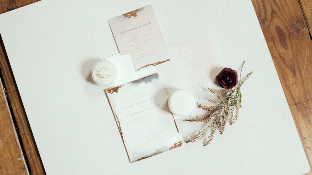 wedding rings, flowers, and invitations
