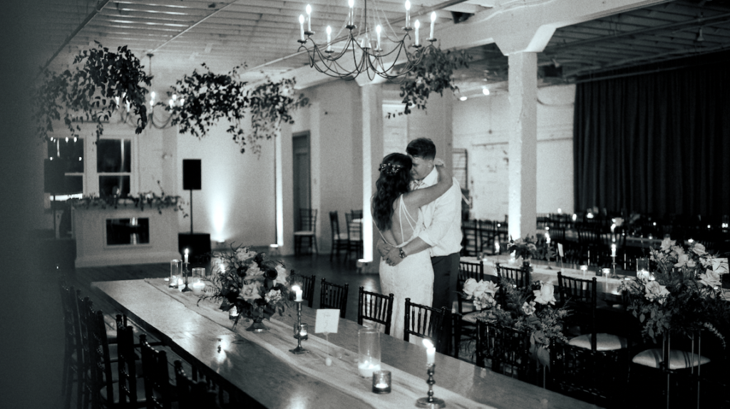 black and white image of a bride and groom slow dancing