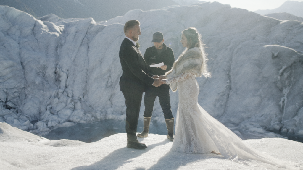 bride and groom during their elopement on a glacier