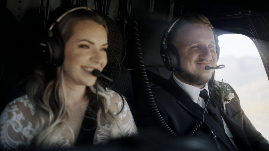 bride and groom in a helicopter with radio headsets on